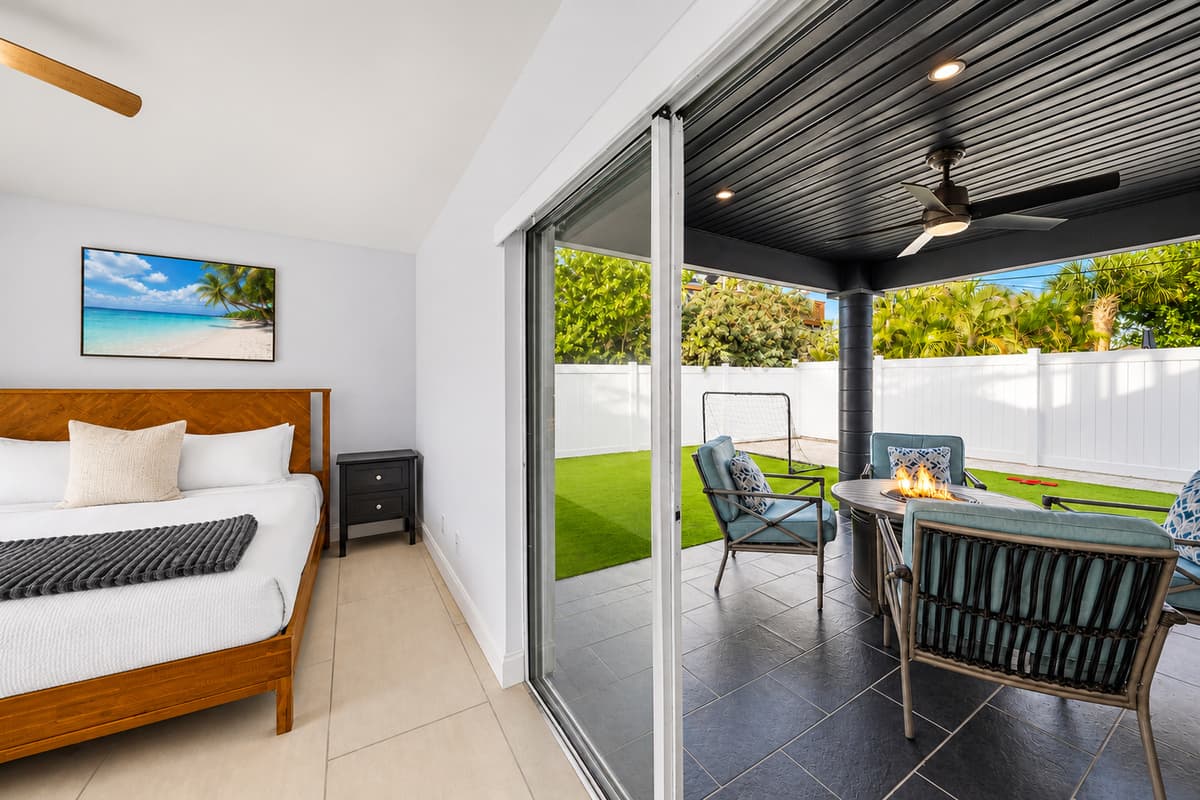 Bedroom view overlooking the covered patio and private outdoor lounge area.