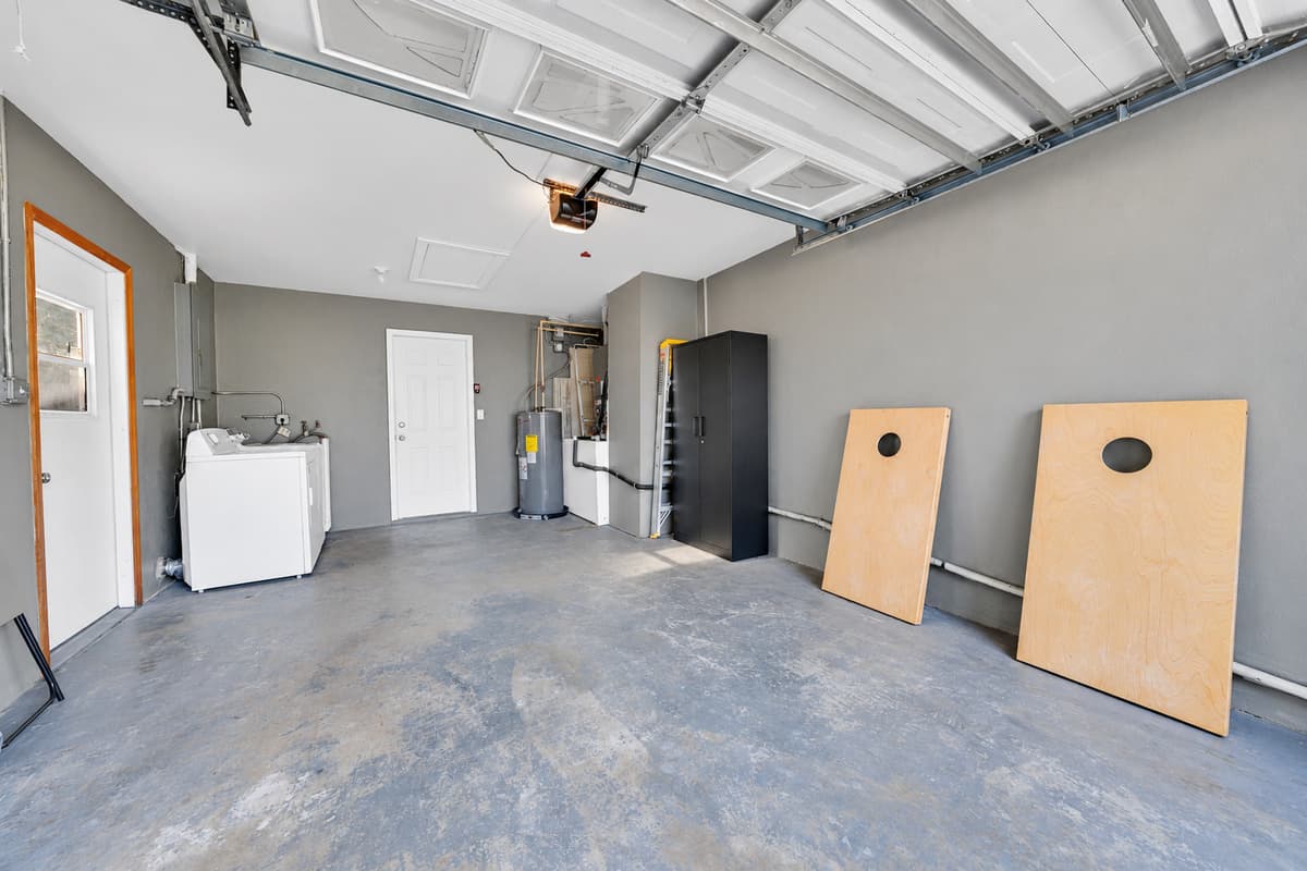 Washer and dryer in the garage — which matters more than it sounds when nine people generate wet towels for a week. The cornhole boards are here too, ready to come out to the backyard any afternoon.