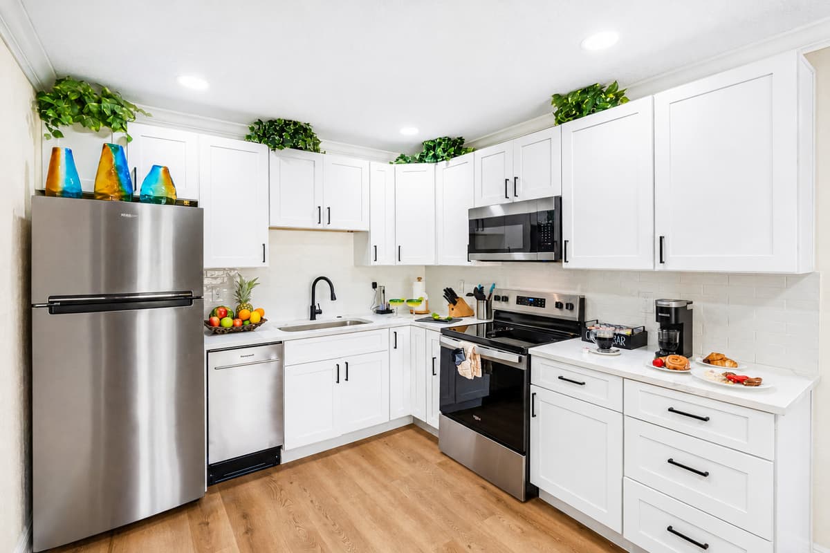 The layout is open and user-friendly, allowing you to move easily between the refrigerator, stove, and prep areas while staying connected to guests in the adjacent dining and living rooms.