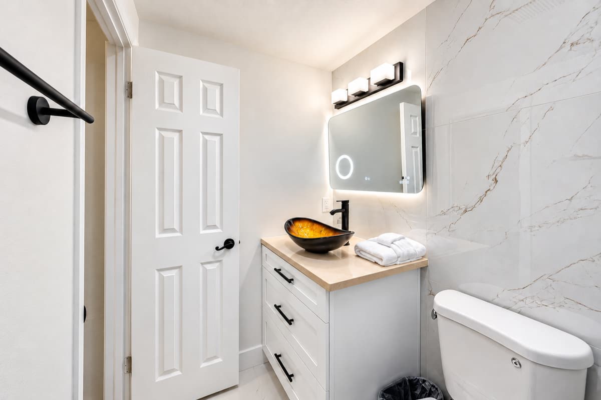 Bedroom 1 - Ensuite
Stylish primary bathroom with contemporary finishes, illuminated mirror, and elegant design touches for a spa-like experience.