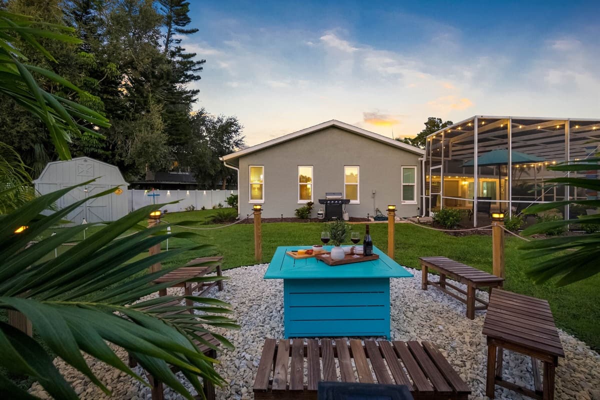 The outdoor area includes a screened-in pool, hammock retreat, firepit with seating, and backyard games—perfect for creating unforgettable memories.