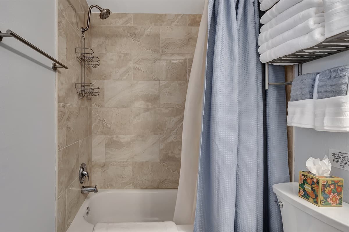 Complete with a sleek walk-in shower, modern toilet, and a chic vanity.