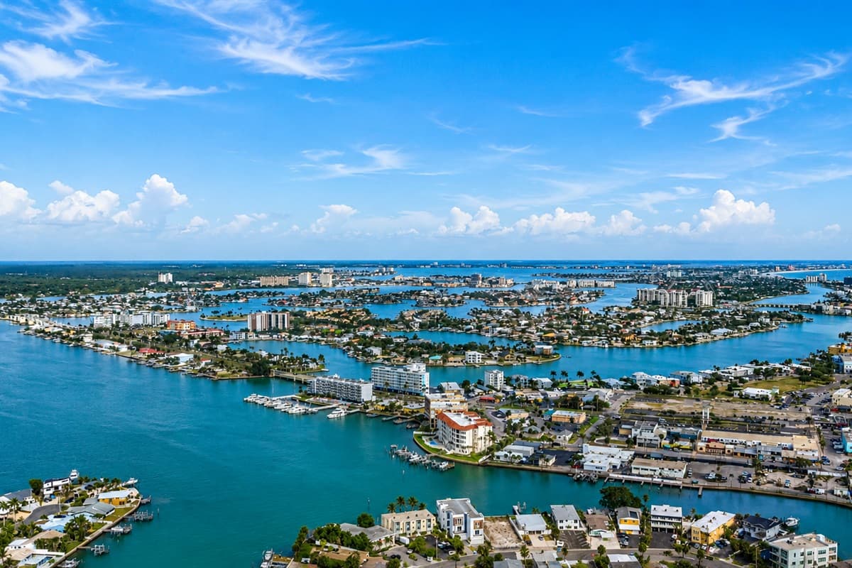 Panoramic aerial view of the surrounding waterways, marinas, and coastal neighborhood.