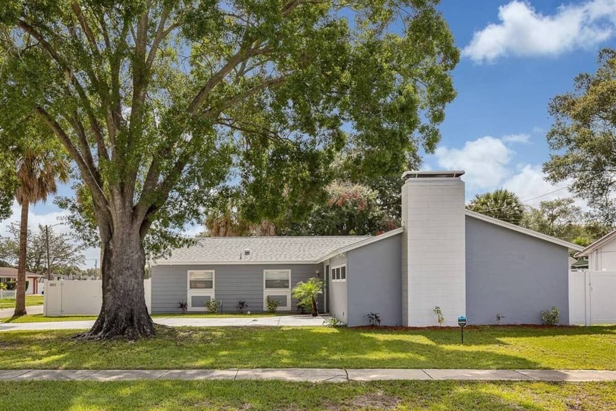 The beautiful side view of the house showcasing our magnificent front yard, amazing tree, and driveway. If you are interested in this property, don't hesitate to send us a message! Book now!