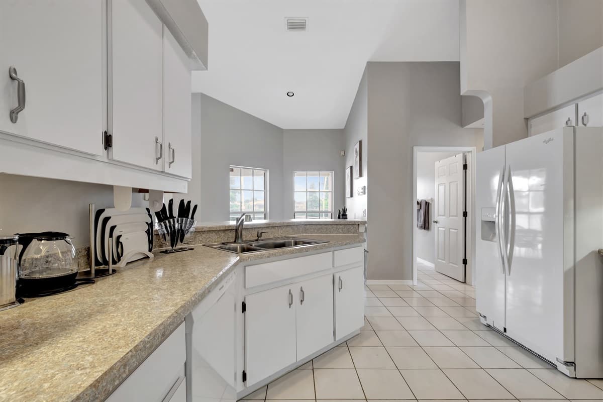 In this kitchen, functionality meets style effortlessly. The exquisite white wooden cupboards, meticulously crafted with precision and unwavering attention to detail.