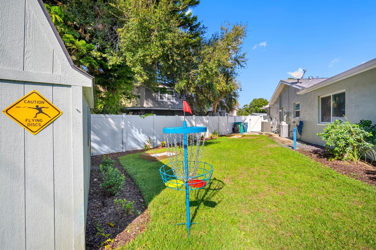 Surrounded by palm trees and greenery, the fully fenced backyard provides peace, privacy, and plenty of fun-filled amenities.