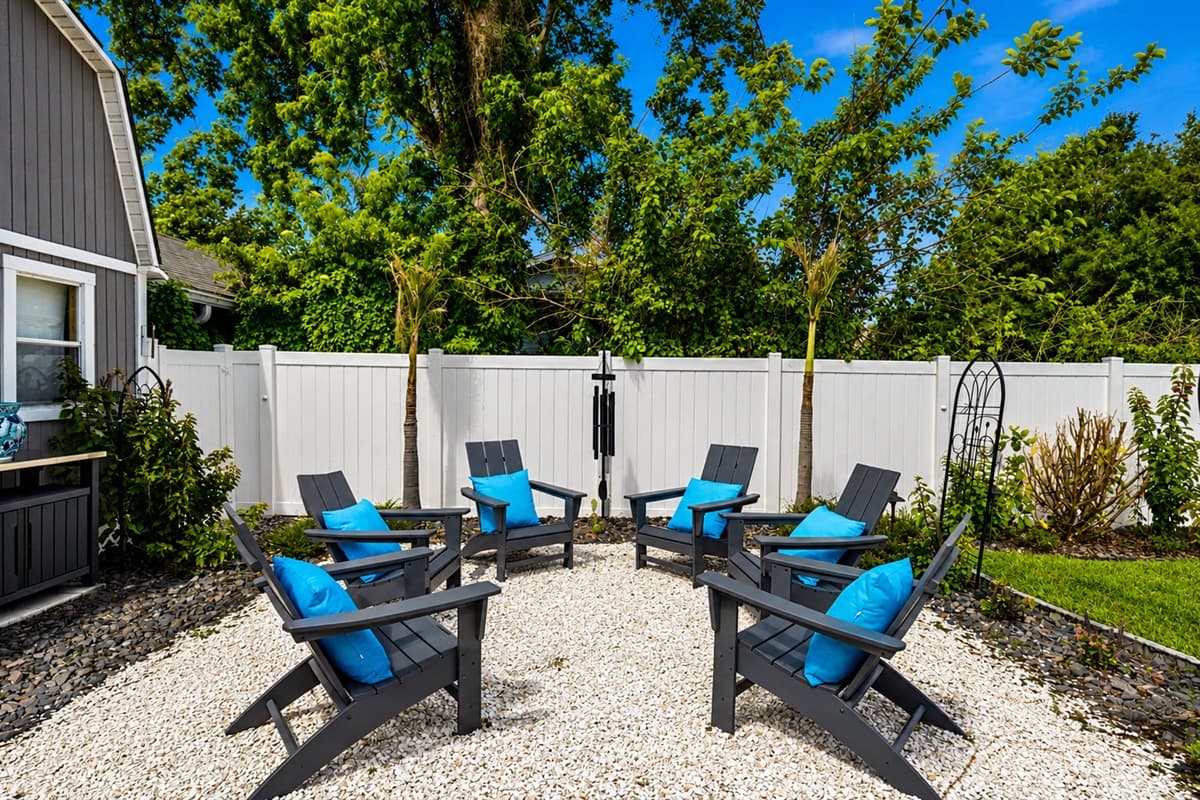 Peaceful backyard lounge area with Adirondack seating — perfect for relaxing evenings and outdoor gatherings.