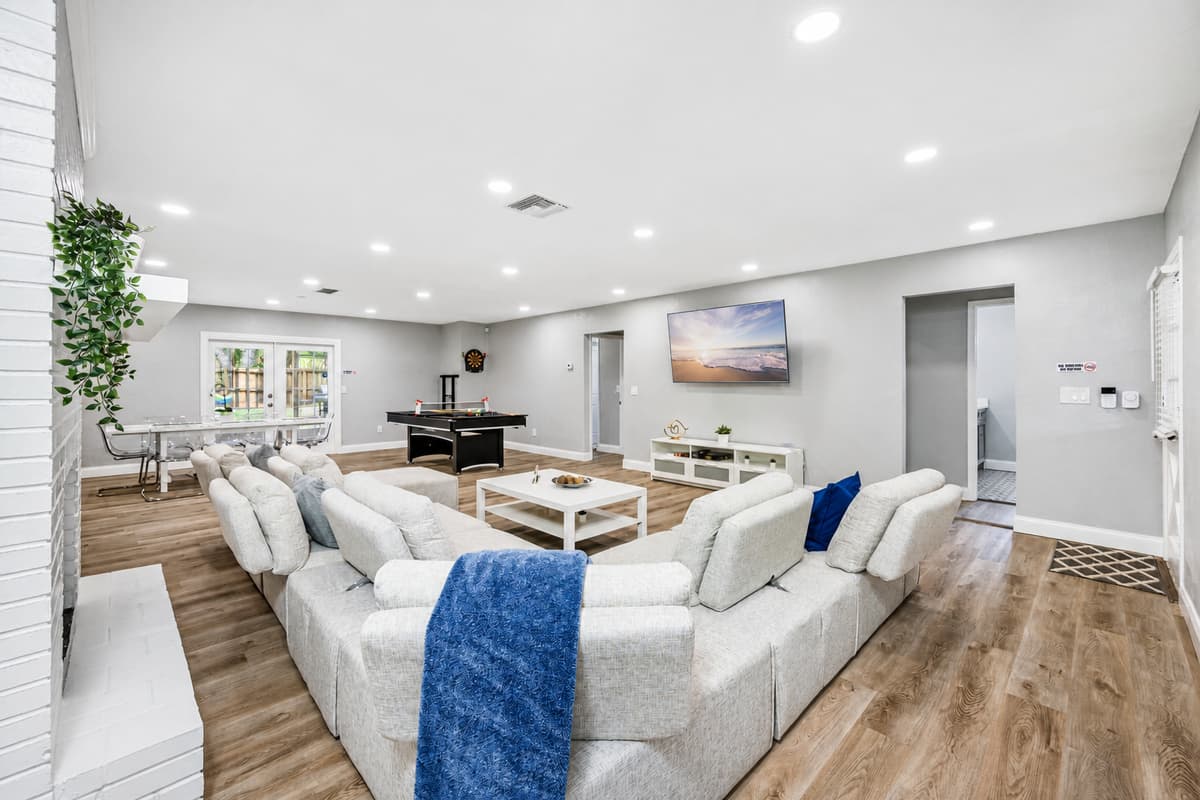 Elegant living room with a beautiful L-shaped couch, smart TV and pool table. relax and enjoy with family and friends in the comfort of your home away from home. Do you love what you see? Send us an inquiry now!