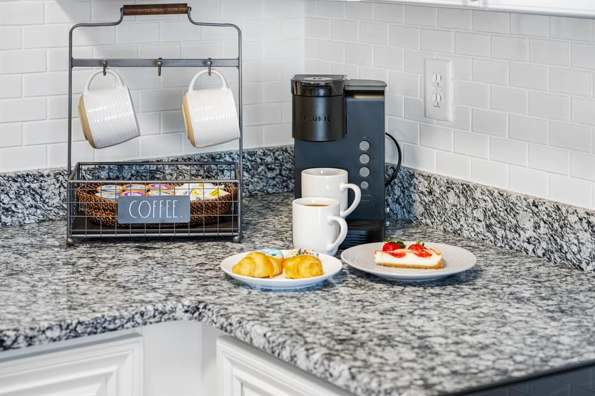 Sleek countertops gleam under the soft glow of pendant lights, while stainless steel appliances stand ready for gastronomic feats.