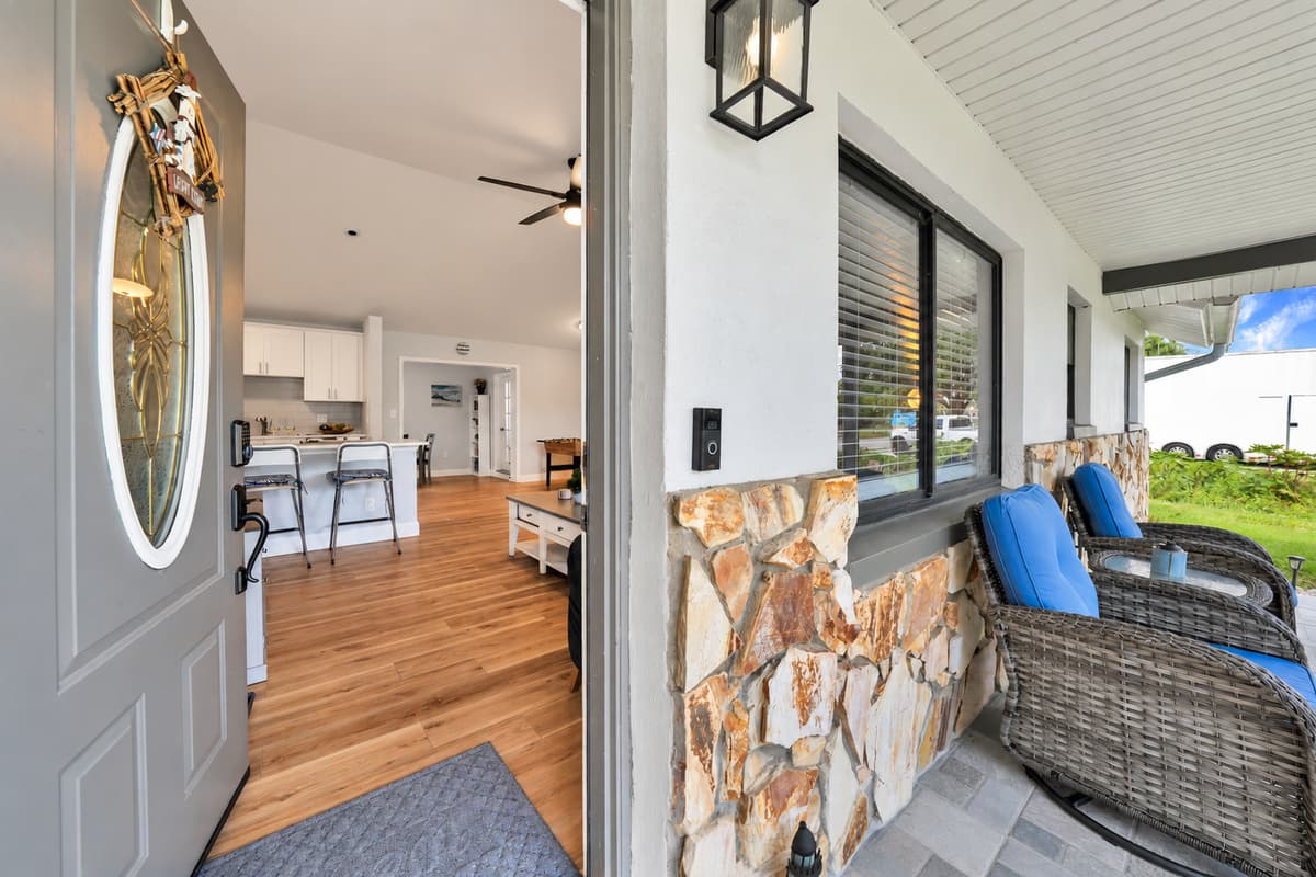 Step out the front door and there's shade, chairs and a stone wall that stays cool. Morning coffee happens here before the sunscreen gets found, and so does the last conversation of most nights.