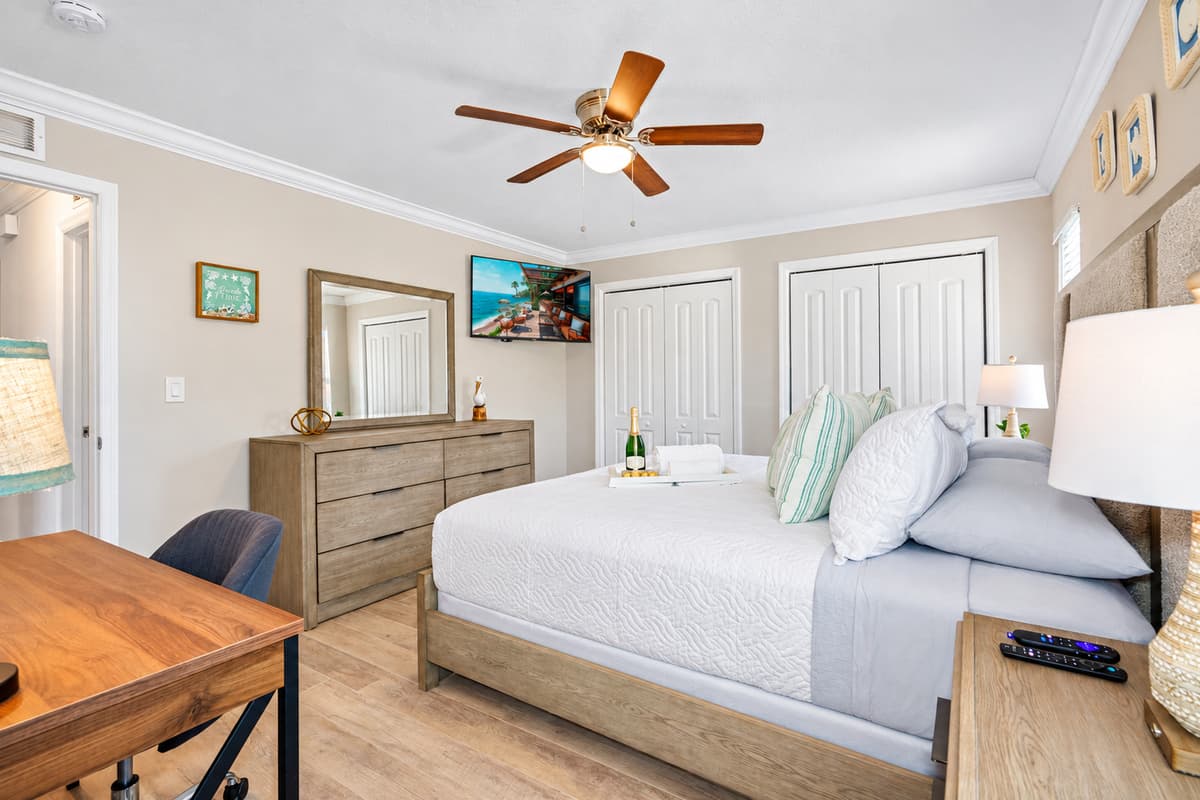 The bed's cozy ambiance is complemented by a stylish dresser, providing ample storage space for your belongings and adding a touch of sophistication to the room.