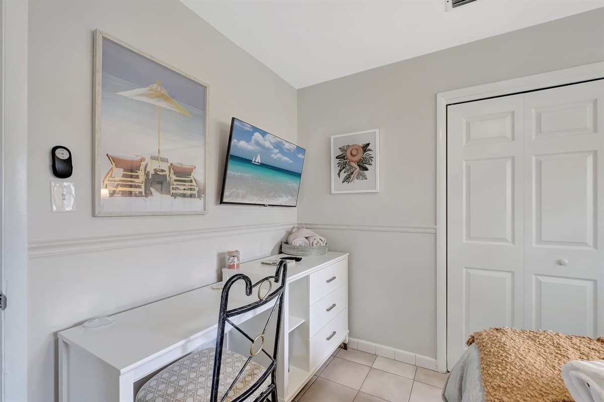 This bedroom features a study or workspace table.