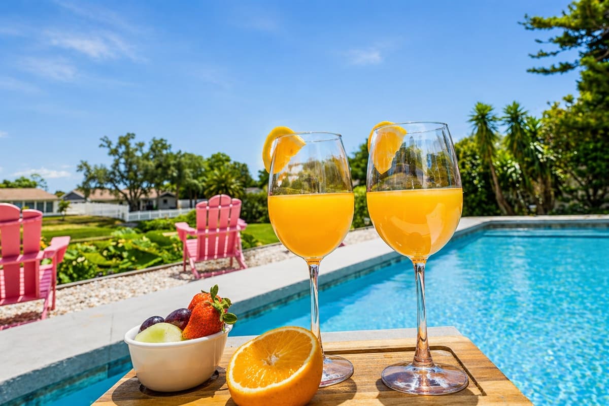 Refreshing poolside setup with drinks and snacks for the perfect sunny afternoon. (Items shown for staging purposes only)