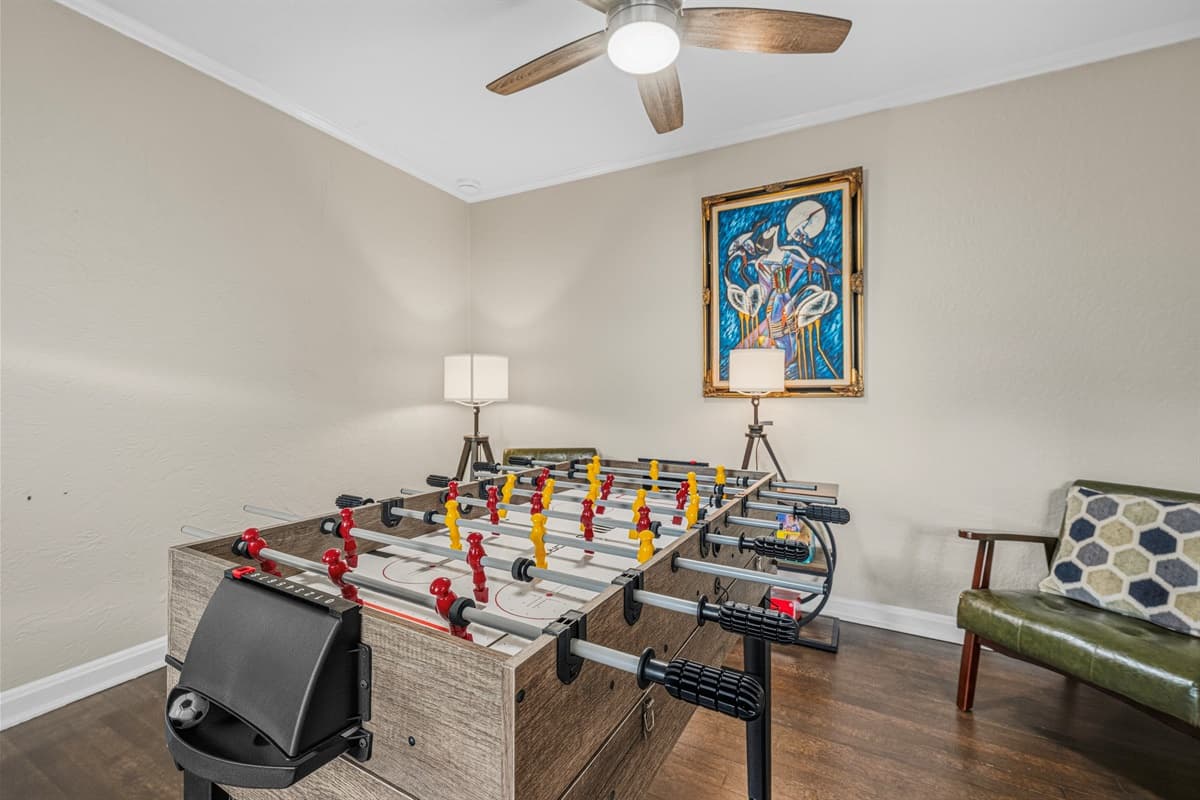 Dedicated game area with foosball table and comfortable seating for game nights.