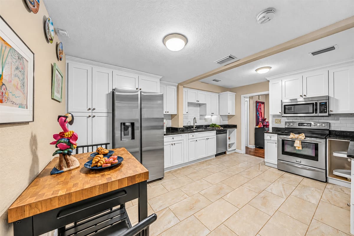 Open kitchen with island workspace and full-size appliances for added convenience.
