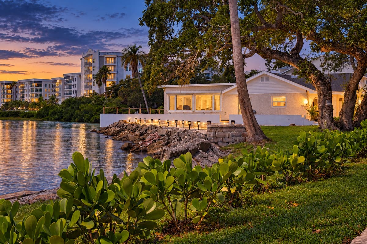 Waterfront side of the home at dusk.