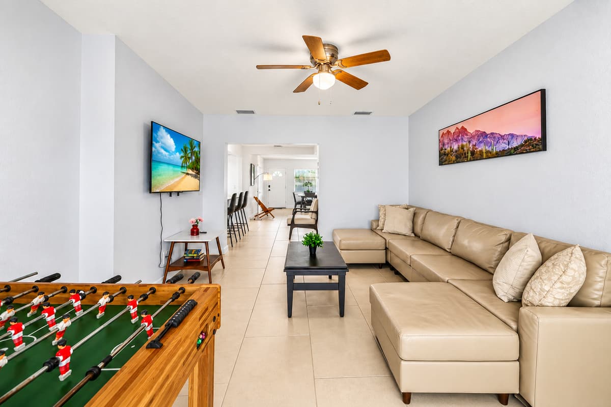 Open living room with foosball table, entertainment space, and cozy sectional seating.