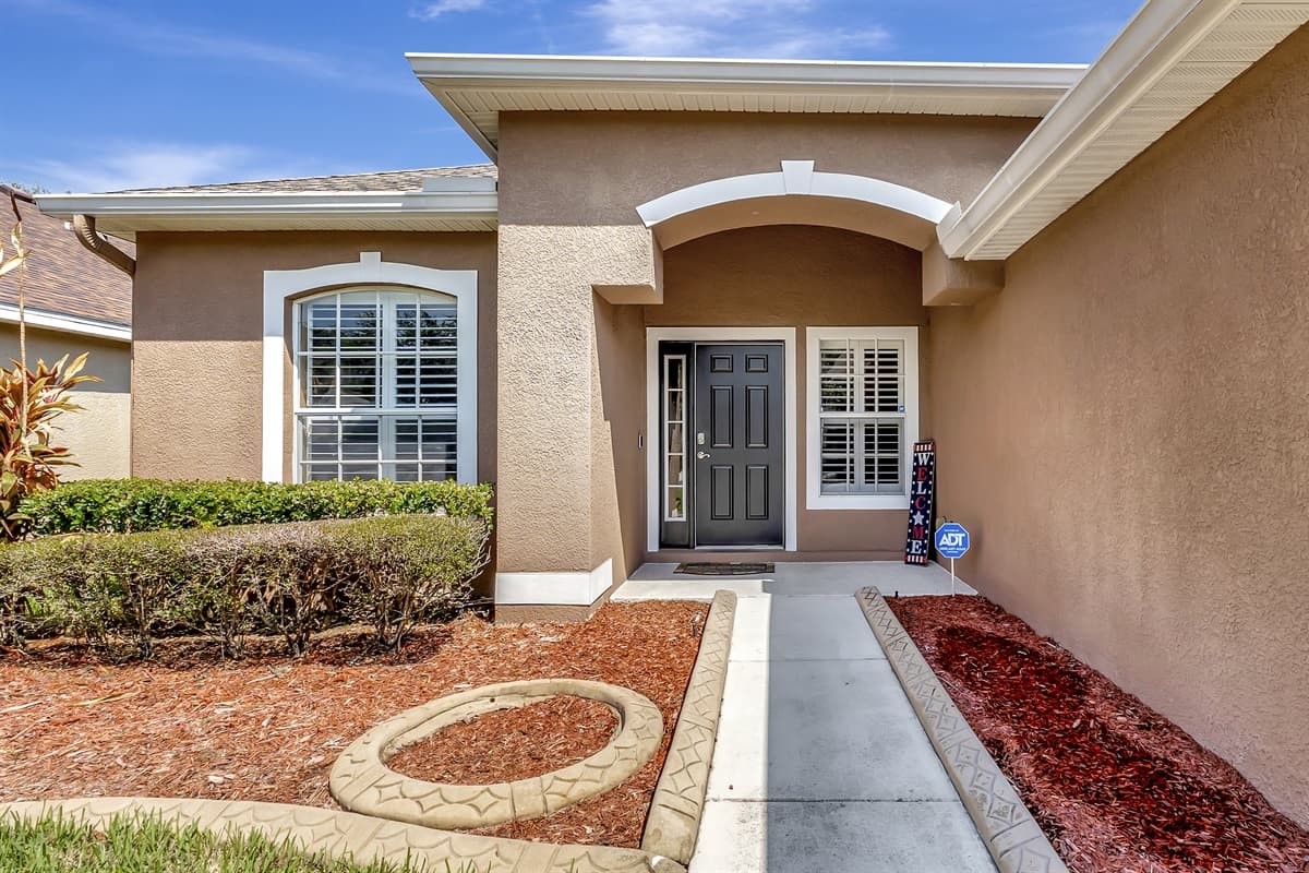 The exquisite home exterior highlights the property's captivating entryway.