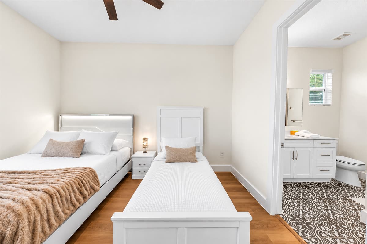 Your bathroom is right through that door. A queen bed, a twin bed, and a private en-suite just steps away. No midnight trips down the hall, perfect for parents with a child or friends who value a little privacy.