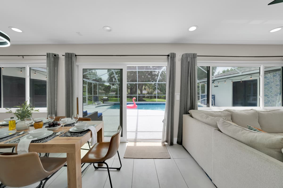 Where indoor comfort meets the beauty of the poolside, framed by open curtains and natural light
