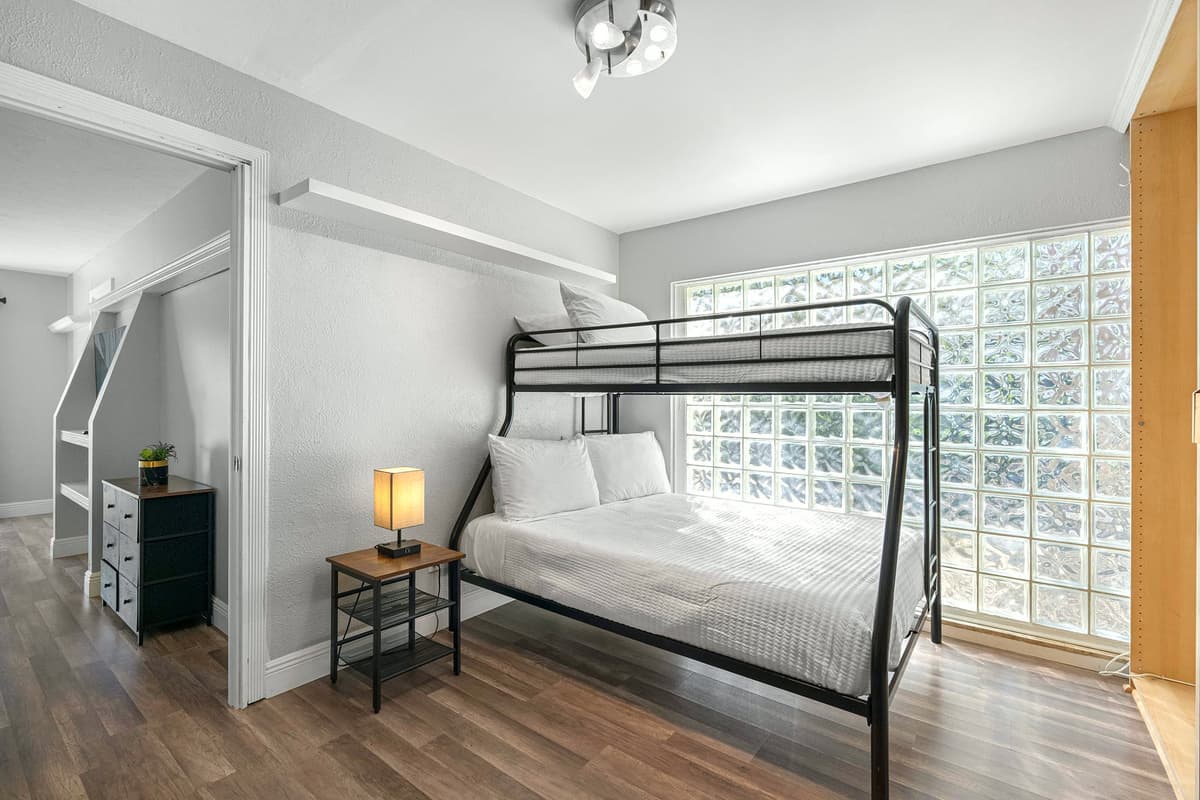 A king bed and nearby bunk setup offer flexibility and comfort for families or groups.