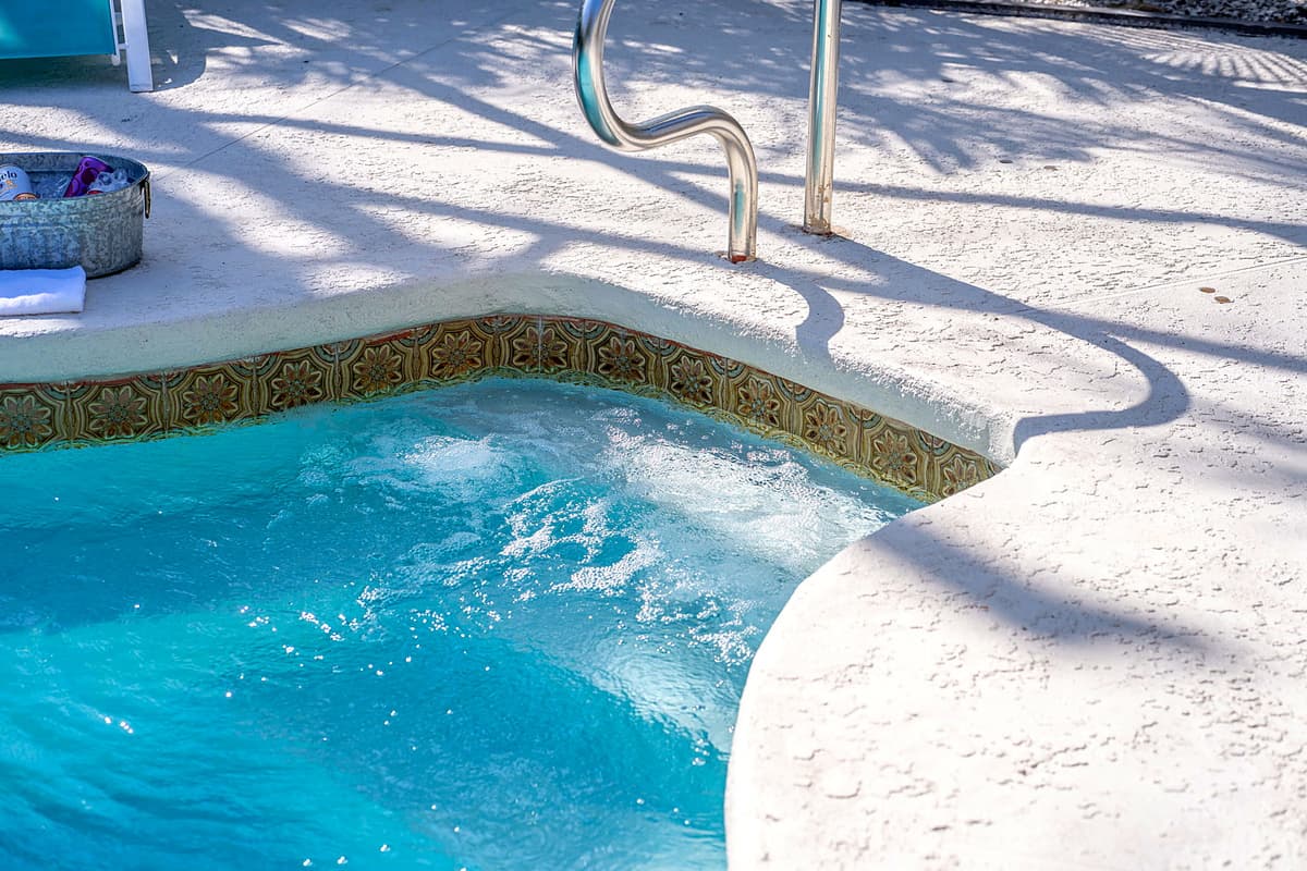The pool is enclosed by a covered net, offering not only safety but also a bug-free environment that ensures you can enjoy the outdoor space comfortably year-round, no matter the weather.