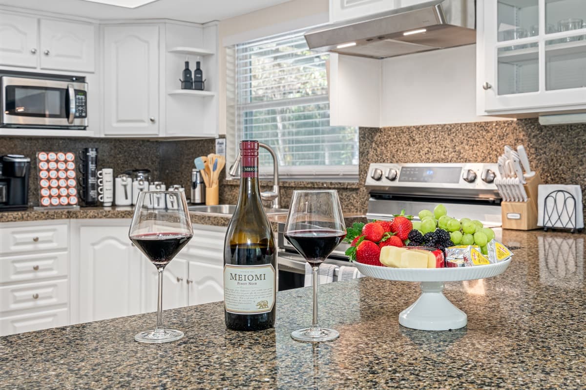 This kitchen is a masterpiece of design, with bright white painted cabinets that instantly elevate the space.