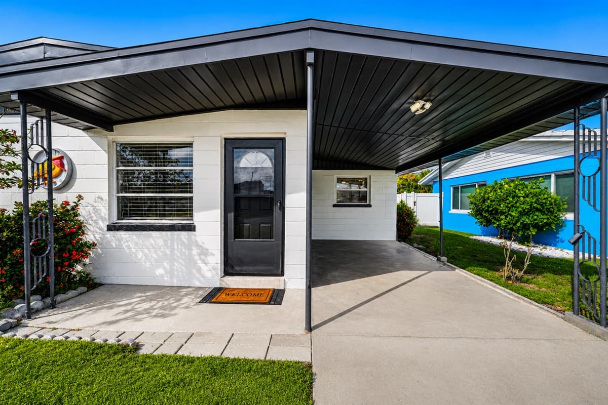 Covered front porch with private driveway access and inviting exterior design.