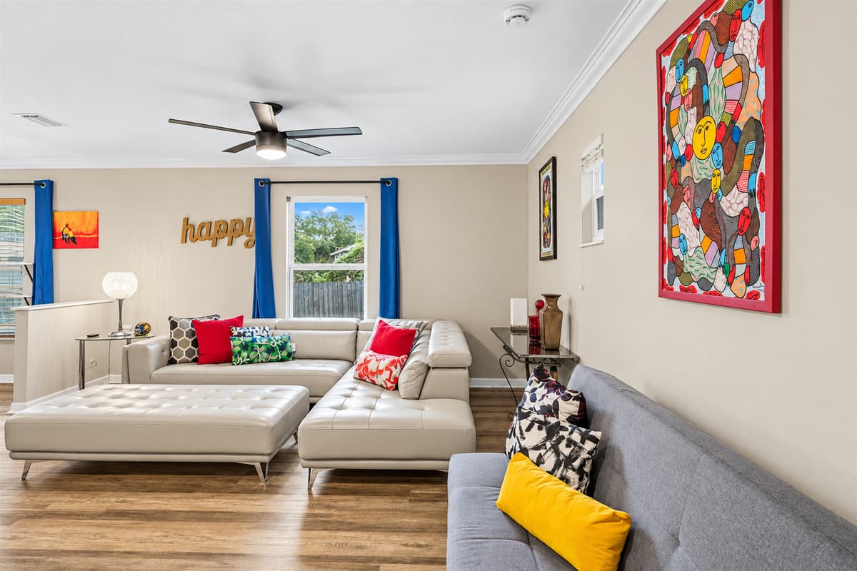 Alternate view of the living space highlighting natural light, modern decor, and roomy layout.
