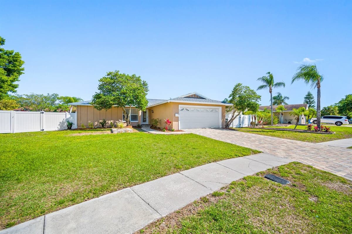 The beautiful side perspective of the house has a wide driveway and a garage. Who doesn't love a view of green grass and beautiful trees around the house? If you like what you see, send us a message as soon as possible!