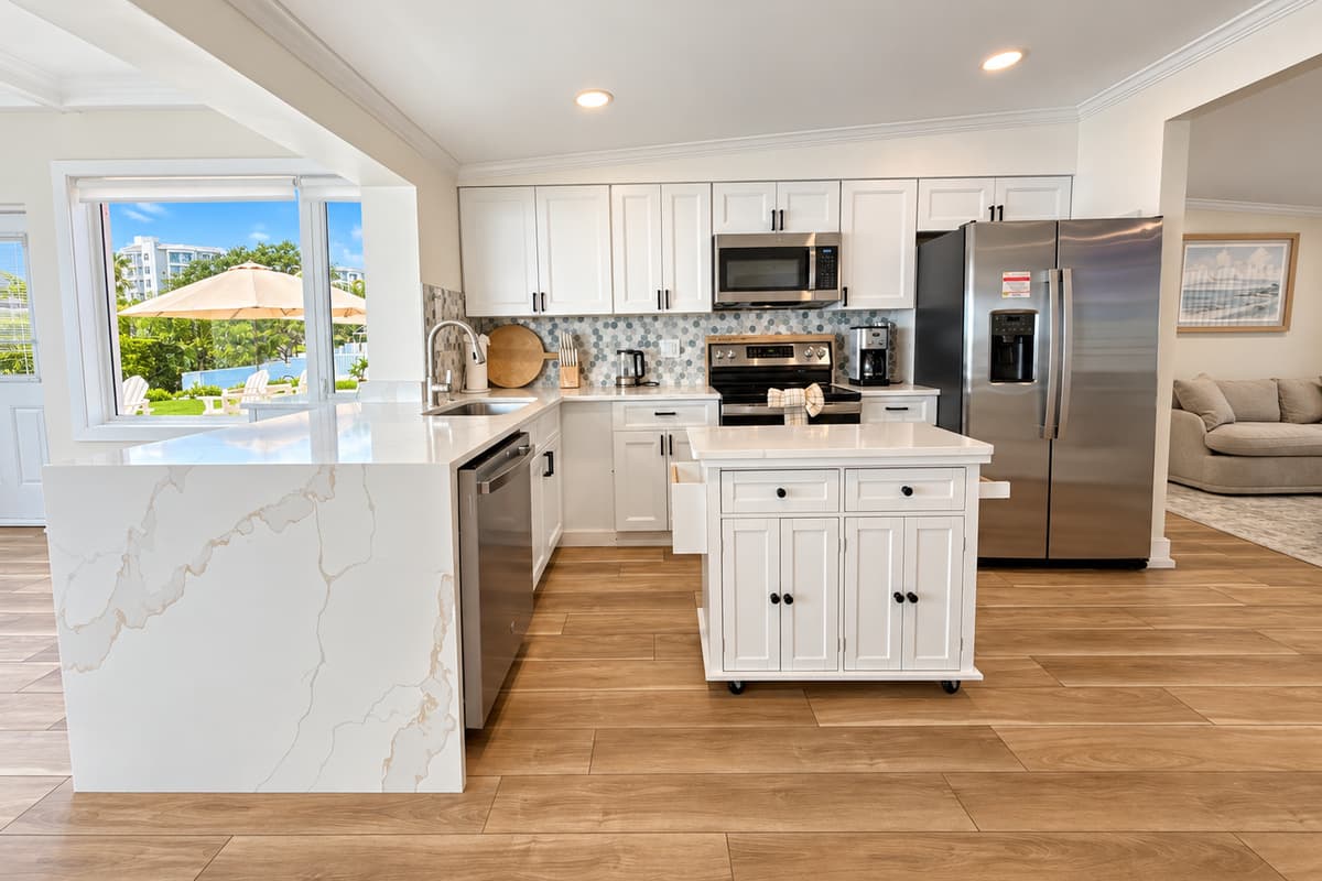 Kitchen with an island, stainless appliances and space to prepare meals.