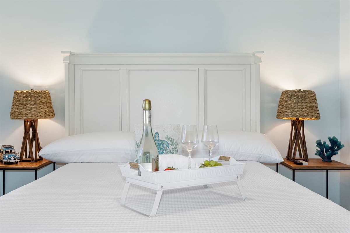 The bedroom features a queen-size bed, outfitted with soft, high-quality linens that promise a restful night’s sleep.
