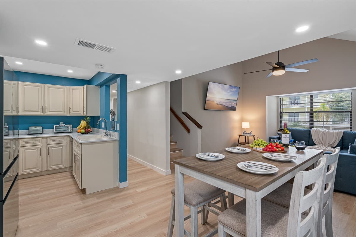 A beautiful wooden 4-seater table awaits, exuding a natural charm and timeless elegance. The smooth, polished surface beckons you to gather around and share delicious meals with family and fri