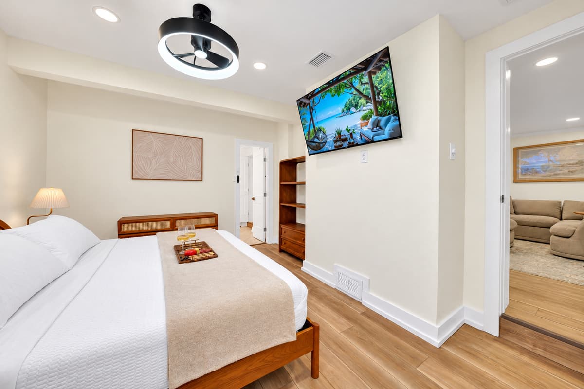 King bed with a TV for lazy evenings. The king bedroom has a wall-mounted TV, a wood headboard and coastal decor. Stretch out and enjoy a movie before bed.