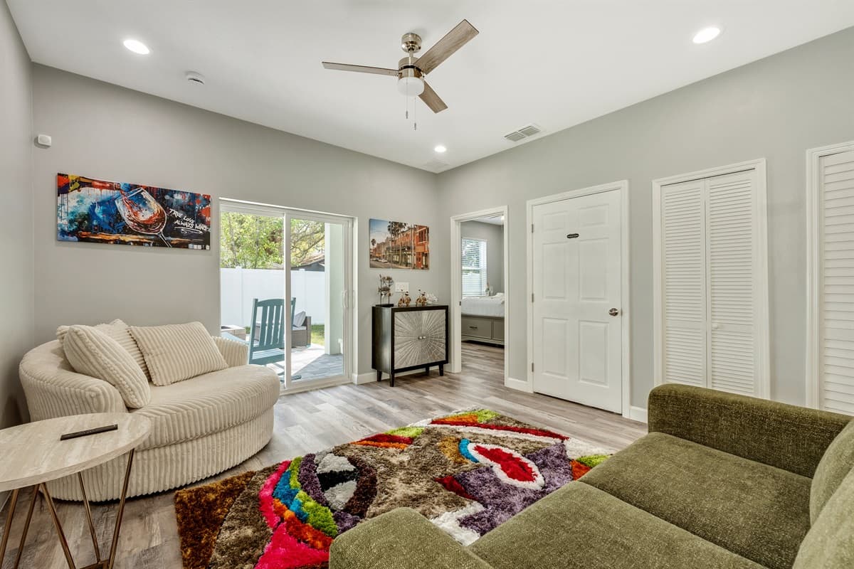 The room is bathed in natural light, thanks to large windows that offer sweeping views of the surrounding landscape.