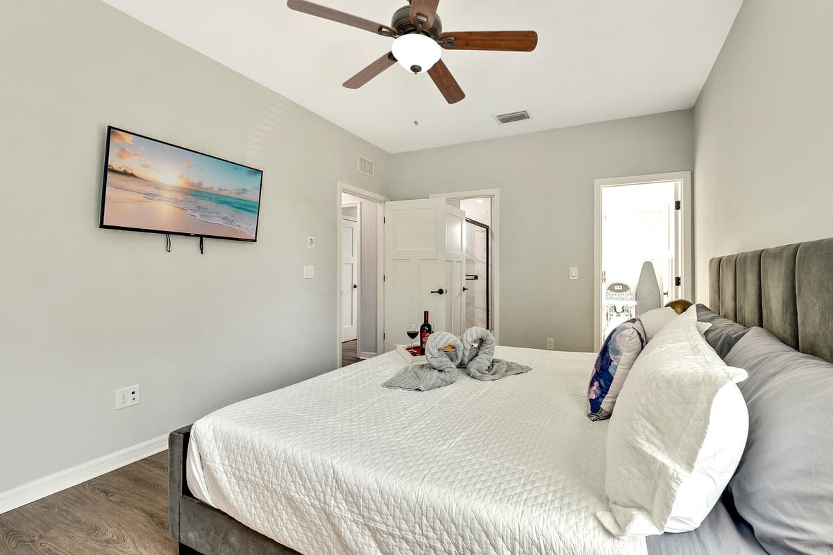 Draped in sumptuous linens and adorned with plush pillows, the bed is a sanctuary of comfort and style.