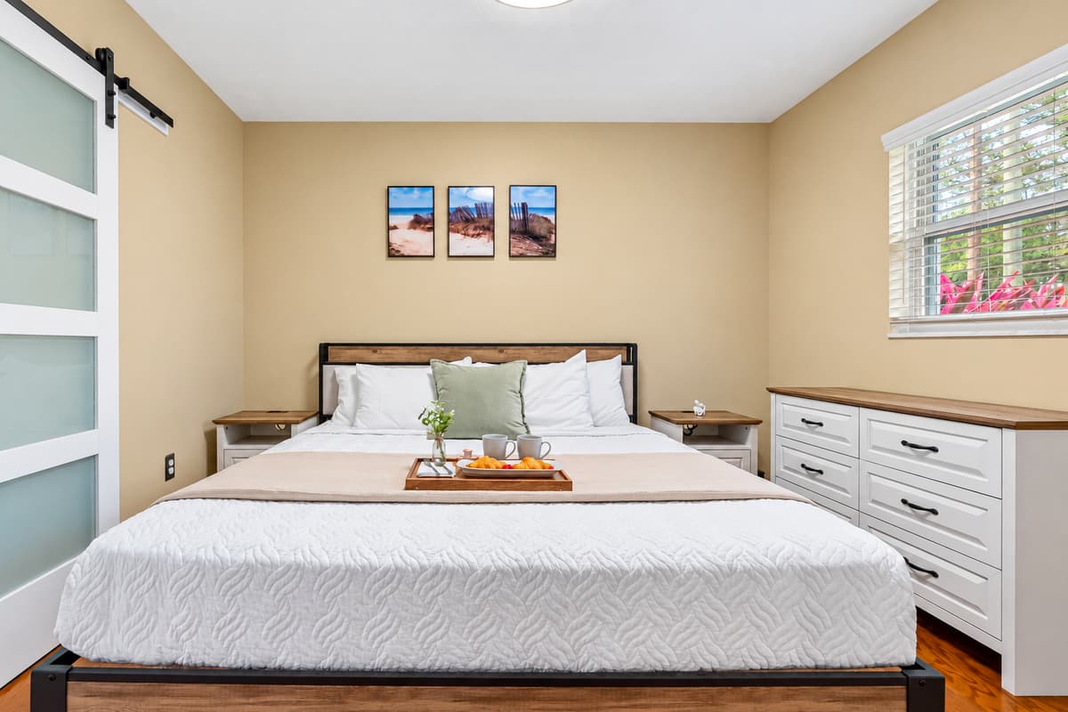 Spacious king bedroom with modern touches and a warm, inviting feel.