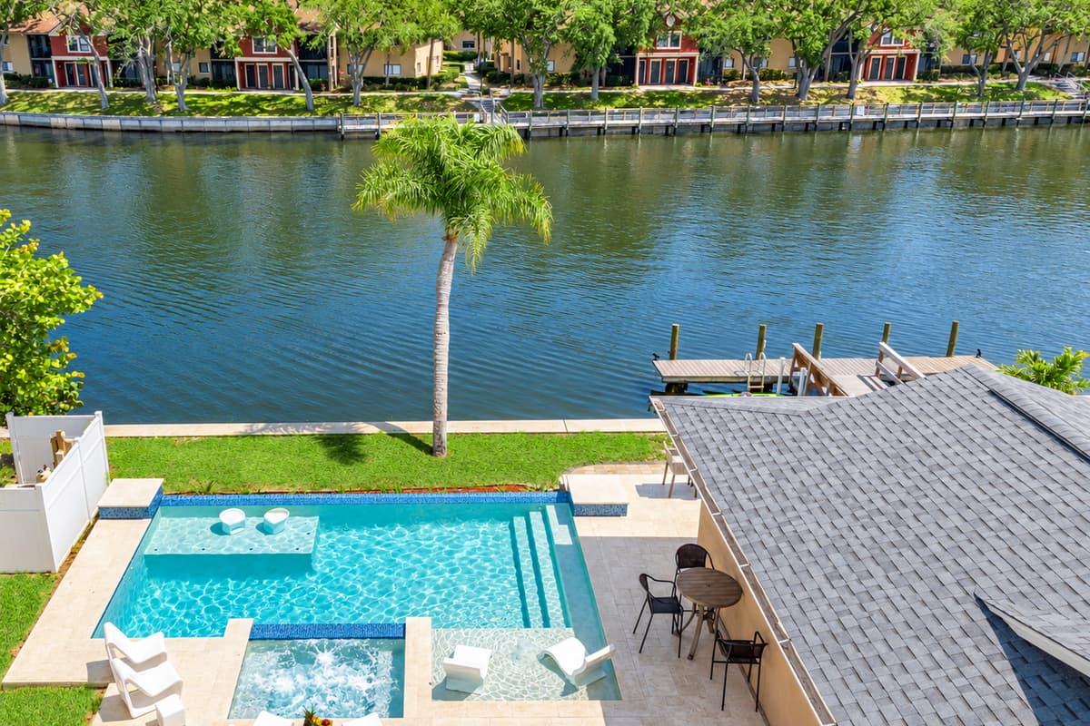 This water canal house with its inviting pool and captivating design is a sanctuary that seamlessly integrates luxurious living with the tranquil beauty of waterfront living.