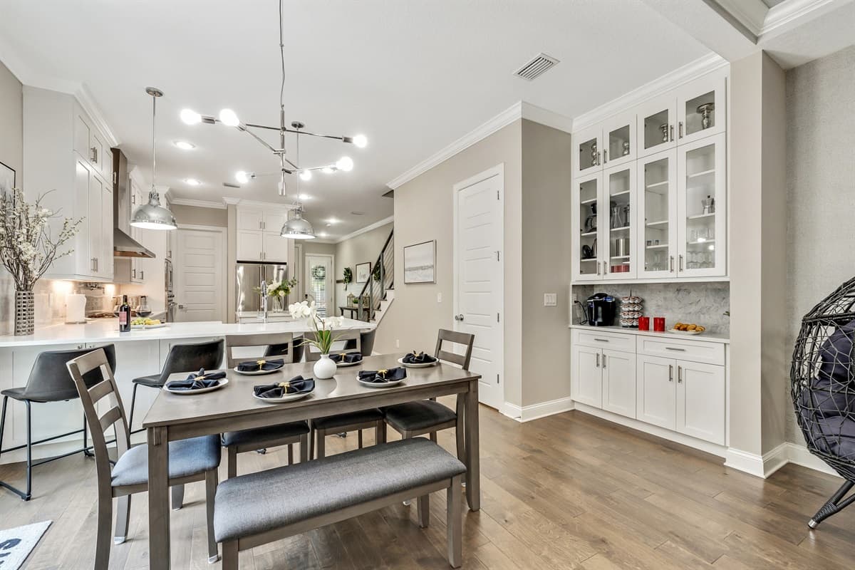 On the other side of the dining area, the fully equipped kitchen stands ready to support your culinary endeavors.