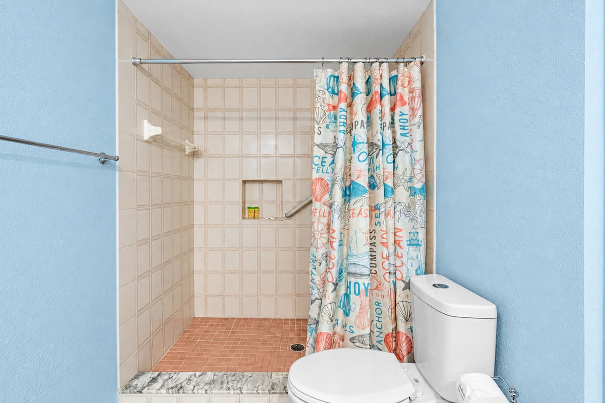 The highlight of the bathroom is the spacious walk-in shower, designed with practicality in mind.