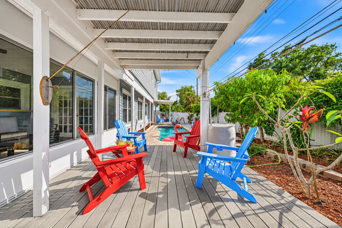 Spacious outdoor deck with colorful seating and shaded areas—perfect for gathering and unwinding 