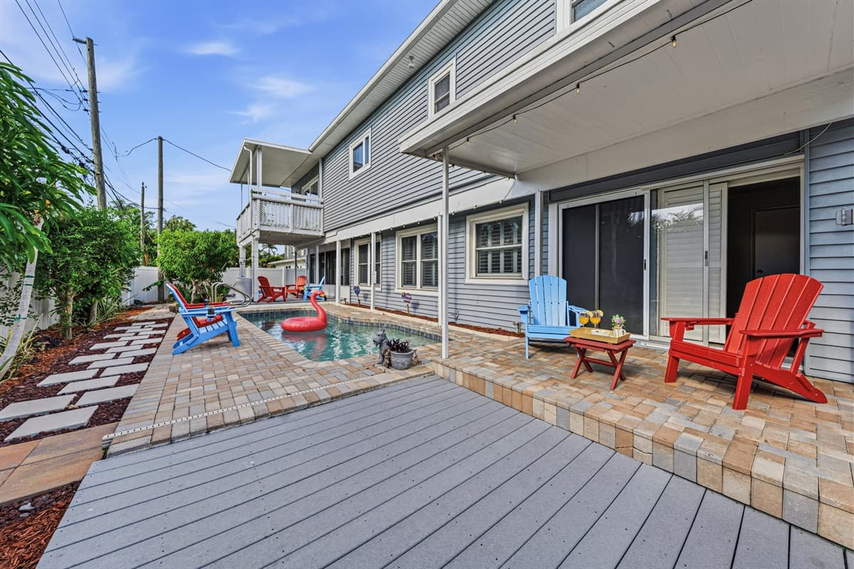 Spacious deck area overlooking the pool with multiple seating spots—perfect for relaxing and entertaining 