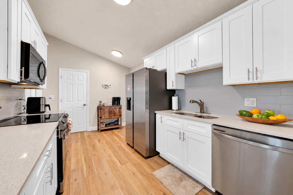 Stove, microwave, dishwasher, air fryer, toaster and blender — this kitchen is stocked for a family that actually cooks. Cook two dinners at home and you've paid for the pool heat.