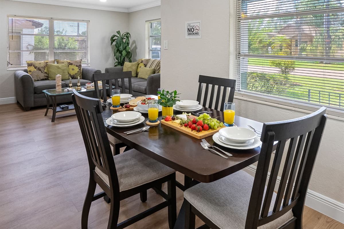 Nestled beside a large window that overlooks the front yard, the dining area is flooded with natural light, offering a warm and welcoming space to start or end your day.