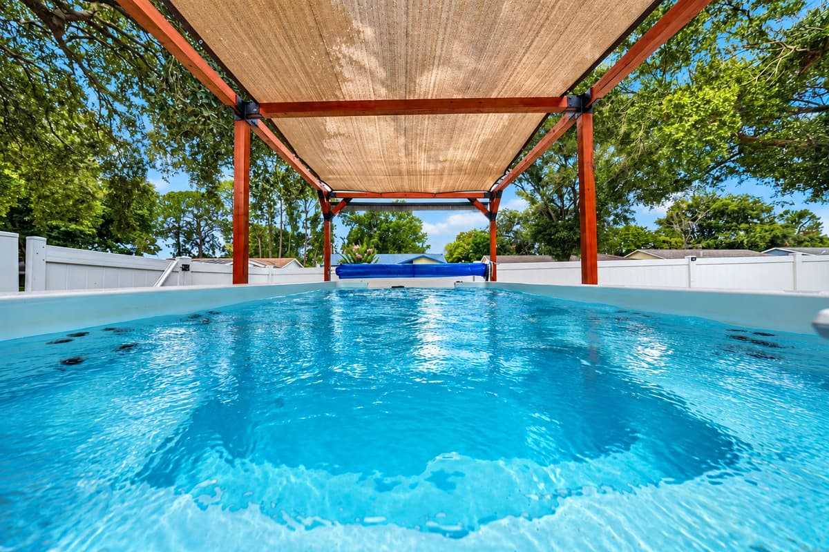 Unwind beneath the shaded pergola in the private swim spa, the perfect place to relax after a day of adventure.