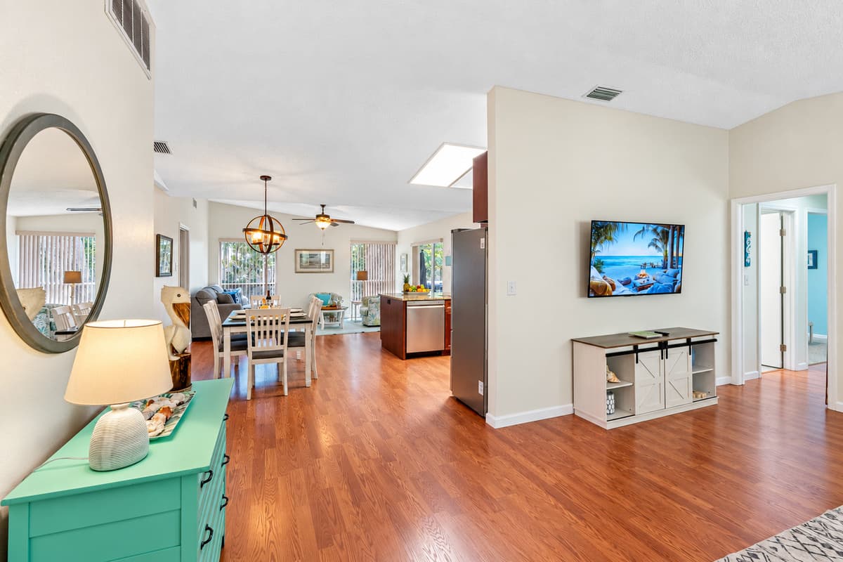 The living room offers a harmonious blend of modern technology and cozy comfort, making it an ideal space for relaxation and entertainment.