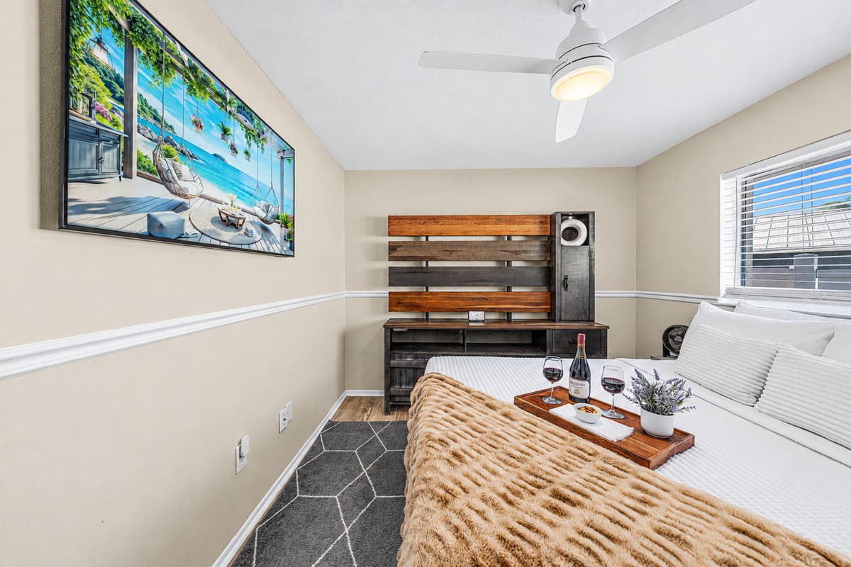 Cozy guest bedroom with a comfortable queen bed, Smart TV, and modern furnishings.