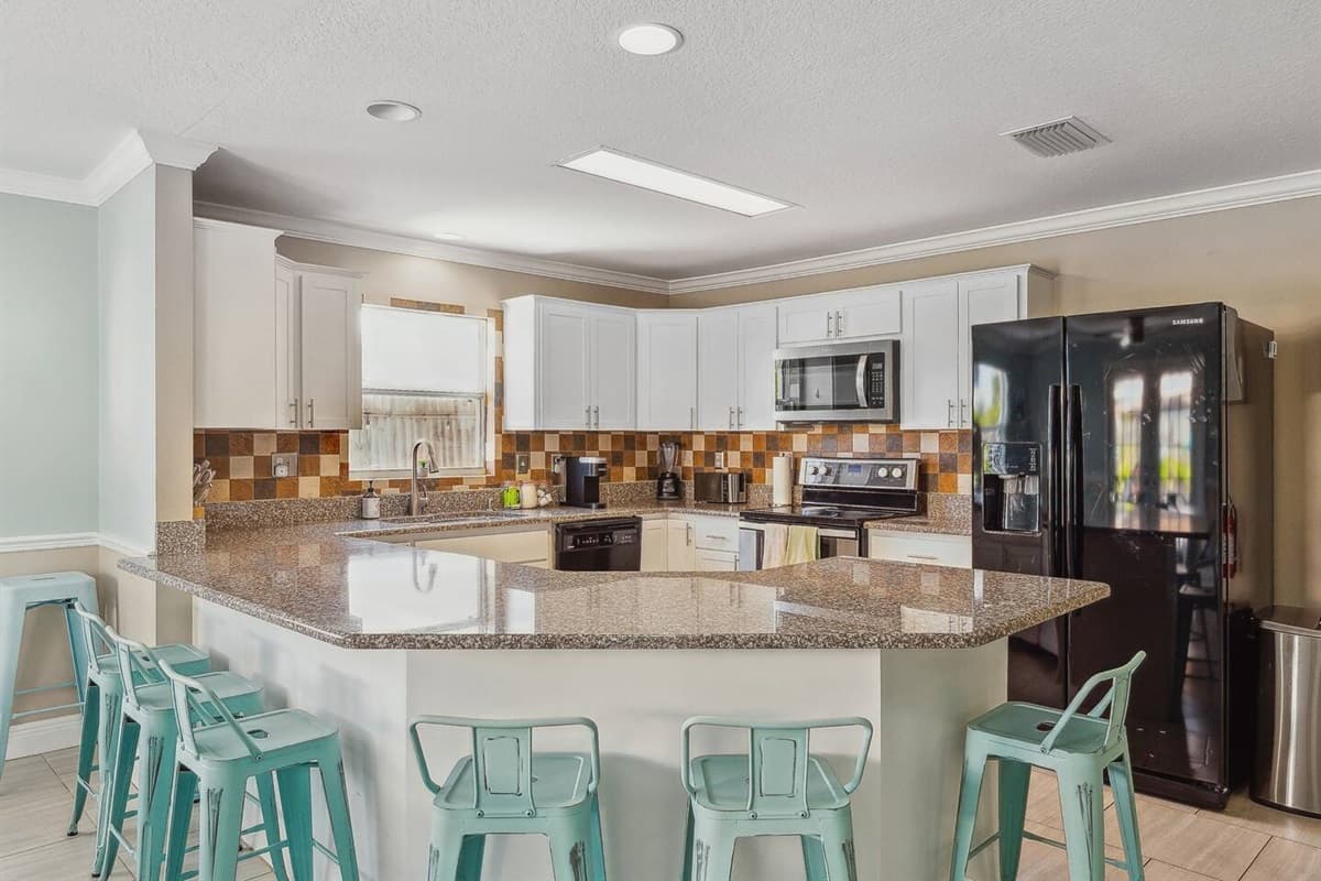 Kitchen with plenty of supplies and chairs for seating for the family