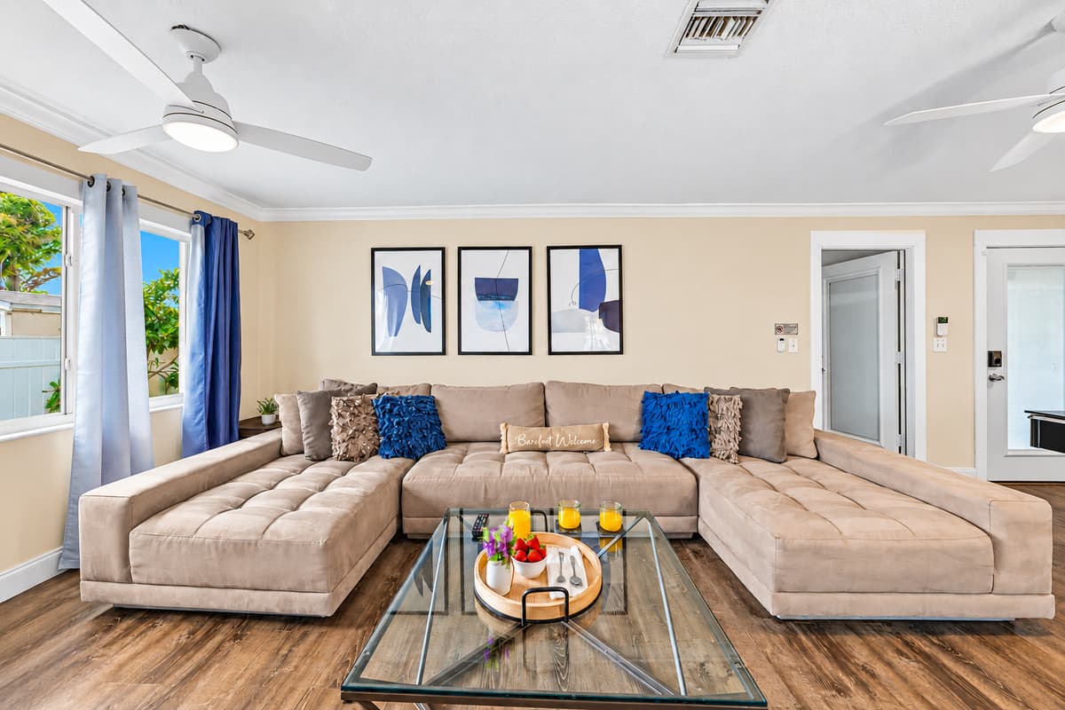 Bright and spacious living room with a large sectional sofa—perfect for relaxing with family and friends.