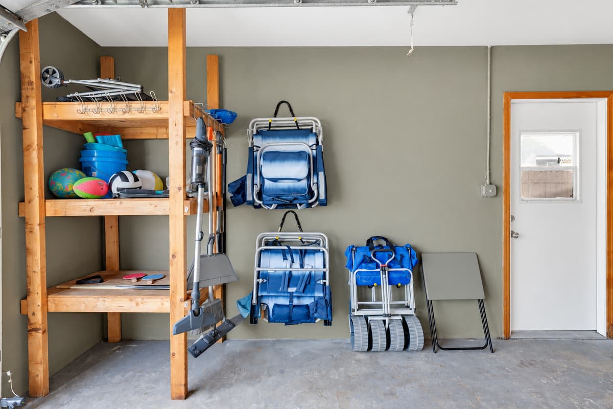 Beach chairs, beach cart, cooler and umbrella, stacked and waiting. That's roughly $200 of gear you didn't have to buy, check on a flight, or drag out of a rental car trunk in the parking lot.